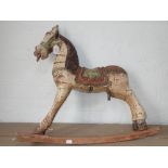 AN INDIAN CARVED AND PAINTED CHILD'S ROCKING HORSE