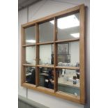 A STRIPPED PINE NINE PANE 'WINDOW' WALL MIRROR