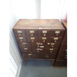 A STAINED HARDWOOD AND PINE CHEMISTS' SHOP CHEST OF DRAWERS