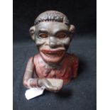 A CAST IRON MECHANICAL BLACK BOY MONEY BOX