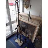 A PAIR OF WROUGHT IRON COAT STANDS ON SCROLLING BASES