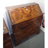 A WALNUT AND CROSS BANDED BUREAU