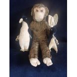 A VINTAGE PLUSH MONKEY with felt hands and face and a black velvet bunny and a similar penguin (3)