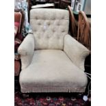 A VICTORIAN UPHOLSTERED ARMCHAIR on turned legs