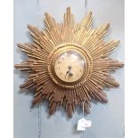 A CARVED AND GILTWOOD SUNBURST CLOCK
