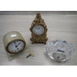 A VICTORIAN MANTEL CLOCK in an alabaster case, a clock in a cut glass case and a baroque style clock