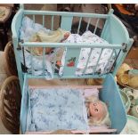 A VINTAGE BLUE PAINTED DOLL'S COT with doll and another similar