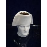 A CONTINENTAL CERAMIC INKWELL in the form of Napoleon's head, 7cm high
