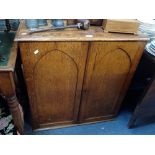 A VICTORIAN OAK TWO DOOR CUPBOARD with Gothic panels, 81cm wide
