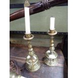 A PAIR OF HEEMSKERK STYLE BRASS CANDLESTICKS 25cms high