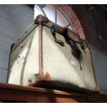 A CANVAS COVERED AND LEATHER TRIMMED TRAVELLING TRUNK