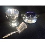 A SILVER EGG CUP, together with a silver salt with blue glass liner and miniature shovel (3)