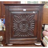 A MID 17TH CENTURY OAK SPICE CUPBOARD, with a carved single door enclosing an arrangement of drawers