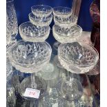A SET OF EIGHT CUT GLASS CHAMPAGNE GLASSES