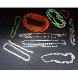 A COLLECTION OF NECKLACES, to include a multi strand coral necklace