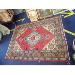 A RED GROUND IRANIAN RUG, 140cm x 192cms