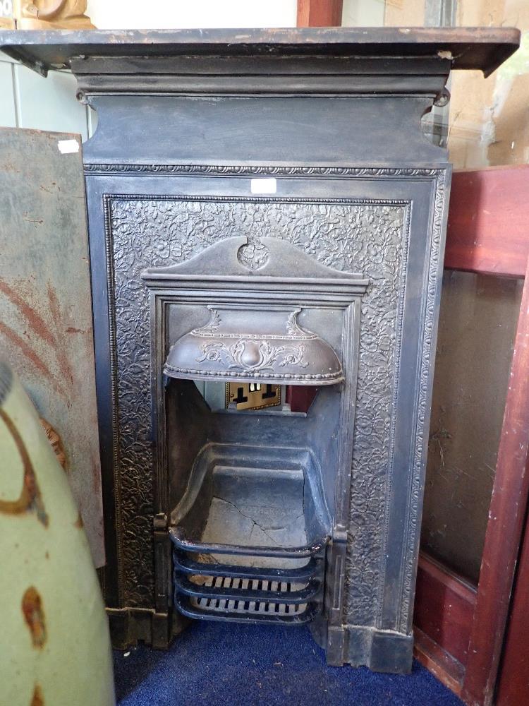 AN EDWARDIAN CAST IRON BEDROOM FIREPLACE; 'THE ROTHERHAM', shelf 69cms wide