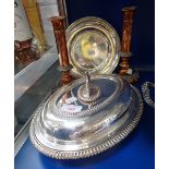 A SILVER PLATED SERVING DISH with cover, a pair of 19th century candlesticks and a plated dish