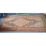 A LARGE PERSIAN STYLE RUG, 202cms by 493cms (worn and faded) and a smaller rug (faded)