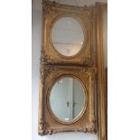 A PAIR OF VICTORIAN GILT FRAMES fitted oval mirrors, each, 44cm high x 39cm wide