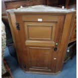 A GEORGE III OAK HANGING CORNER CUPBOARD