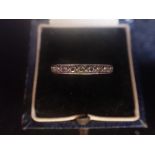 A DIAMOND ETERNITY RING, on unmarked white metal, ring size J