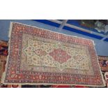 A CREAM GROUND PERSIAN STYLE RUG, 94cms x 153cms (faded and frayed)