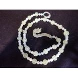 A CHINESE BOWENITE GRADUATED BEAD NECKLACE, with dragon clasp, 70cm long