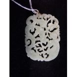 A CARVED JADE OPENWORK PENDANT, 6CM X 4.3CM, with double ring suspension