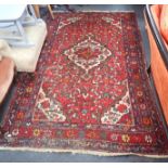 AN IRANIAN STYLE RUG, 134cms x 200cms (worn and insect damage) with flat woven runner and two throws