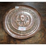 AN ARTS AND CRAFTS REPOUSSE COPPER DISH; 'ALL THE WORLD'S A STAGE….'