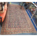 A BLUE GROUND PERSIAN DESIGN RUG, 159cms x 257cms (worn, holed and frayed)