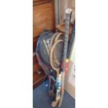 A COLLECTION OF TENNIS RACQUETS AND HOCKEY STICKS