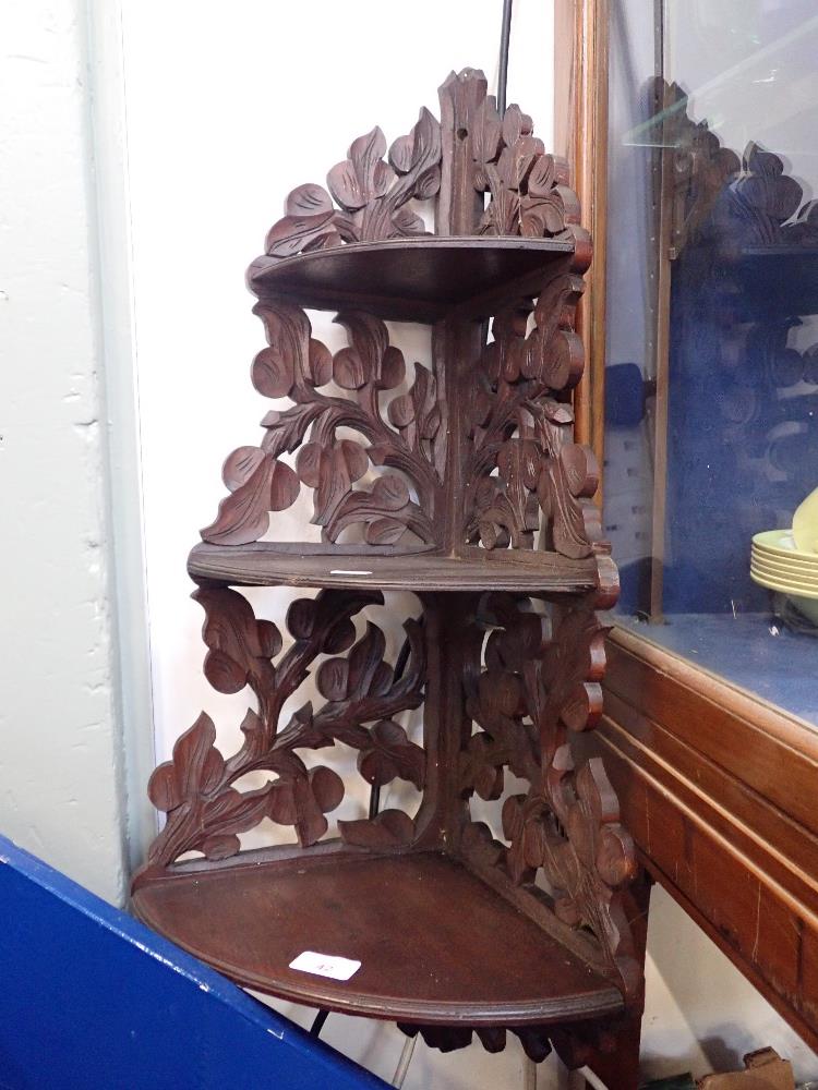 A BLACK FOREST STYLE THREE TIER CORNER SHELF