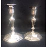 A PAIR OF SILVER CANDLESTICKS