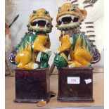 A PAIR OF CHINESE GLAZED POTTERY TEMPLE LIONS, 31cm high
