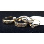 A COLLECTION OF DRESS RINGS, to include a three stone diamond gypsy style ring (4)