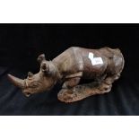 AN AFRCAN CARVED WOODEN STUDY OF A RHINO, 37cm long