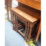 A NEST OF OAK TABLES and two rattan conservatory tables (3)