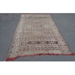 A LARGE TRIBAL STYLE CARPET with allover geometric decoration, width 195cm x 290cm long