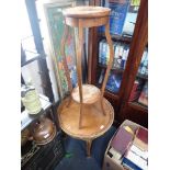 A ROCOCO STYLE CIRCULAR WALNUT COFFEE TABLE and a plant stand (2)