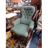 A VICTORIAN WALNUT BUTTON BACK ARMCHAIR