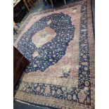 A BLUE GROUND WILTON TYPE CARPET WITH A PERSIAN PATTERN, length 404cm, width 320cm