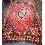 A RED GROUND PRAYER RUG WITH PERSIAN STYLE DETAILS with a central diamond, length 209cm, width 138cm