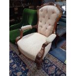 A LATE VICTORIAN WALNUT ARMCHAIR upholstered in peach material