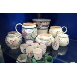 A COLLECTION OF POOLE POTTERY with traditional hand painted decoration