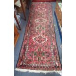 A PINK GROUND PERSIAN STYLE RUNNER, length 200cm, width 65cm, AND A RED GROUND PERSIAN STYLE RUG, le