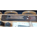 A LEATHER COVERED WOODEN STROP, another similar and a boot pull (3)