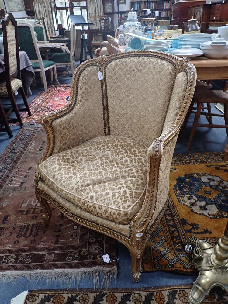 A FRENCH STYLE TUB CHAIR with gilt decoration upholstered in velvet brocade