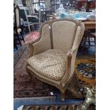 A FRENCH STYLE TUB CHAIR with gilt decoration upholstered in velvet brocade